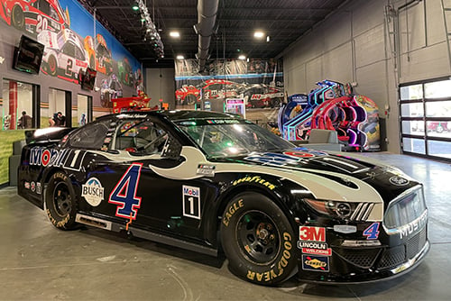 the lobby of k1 speed rogers in arkansas featuring a nascar vehicle