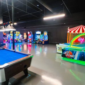 the arcade within k1 speed traverse city with a pool table, video games, and more