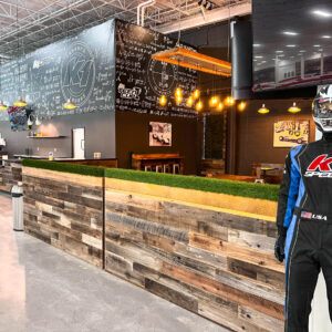 an interior shot of K1 speed knoxville showing the paddock lounge and a mannequin wearing a k1 speed race suit